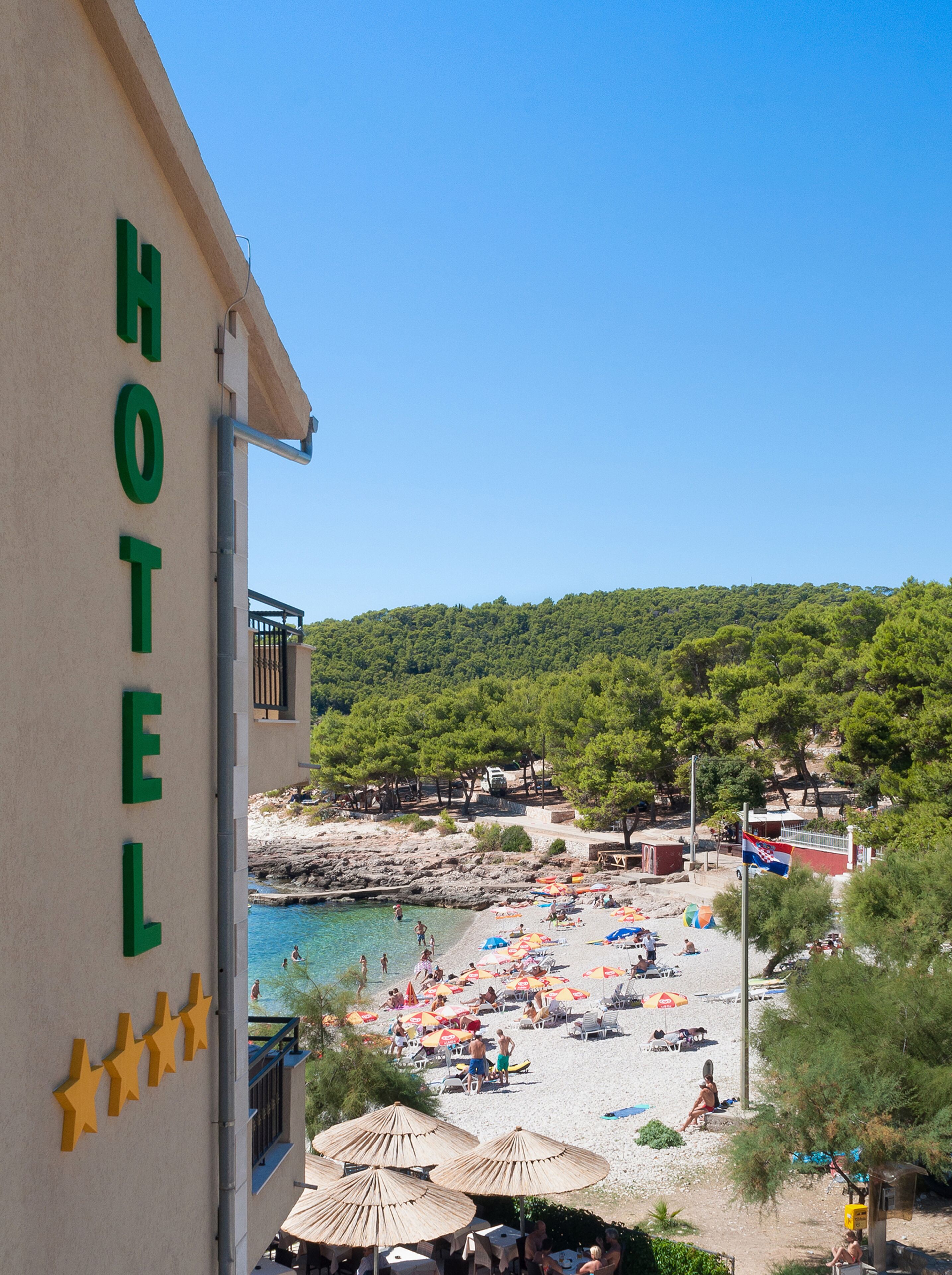 A hotel with a pool and beach area.