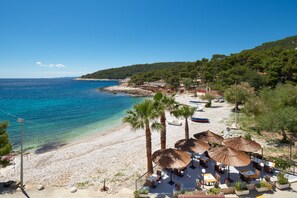 On the beach, sun-loungers, beach umbrellas, beach towels