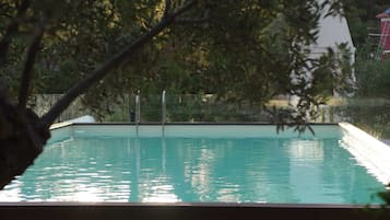 Seasonal outdoor pool, open 11:00 AM to 10:00 PM, pool umbrellas