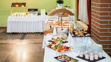 Un tavolo per buffet con diversi cibi e una postazione per il caffè.
