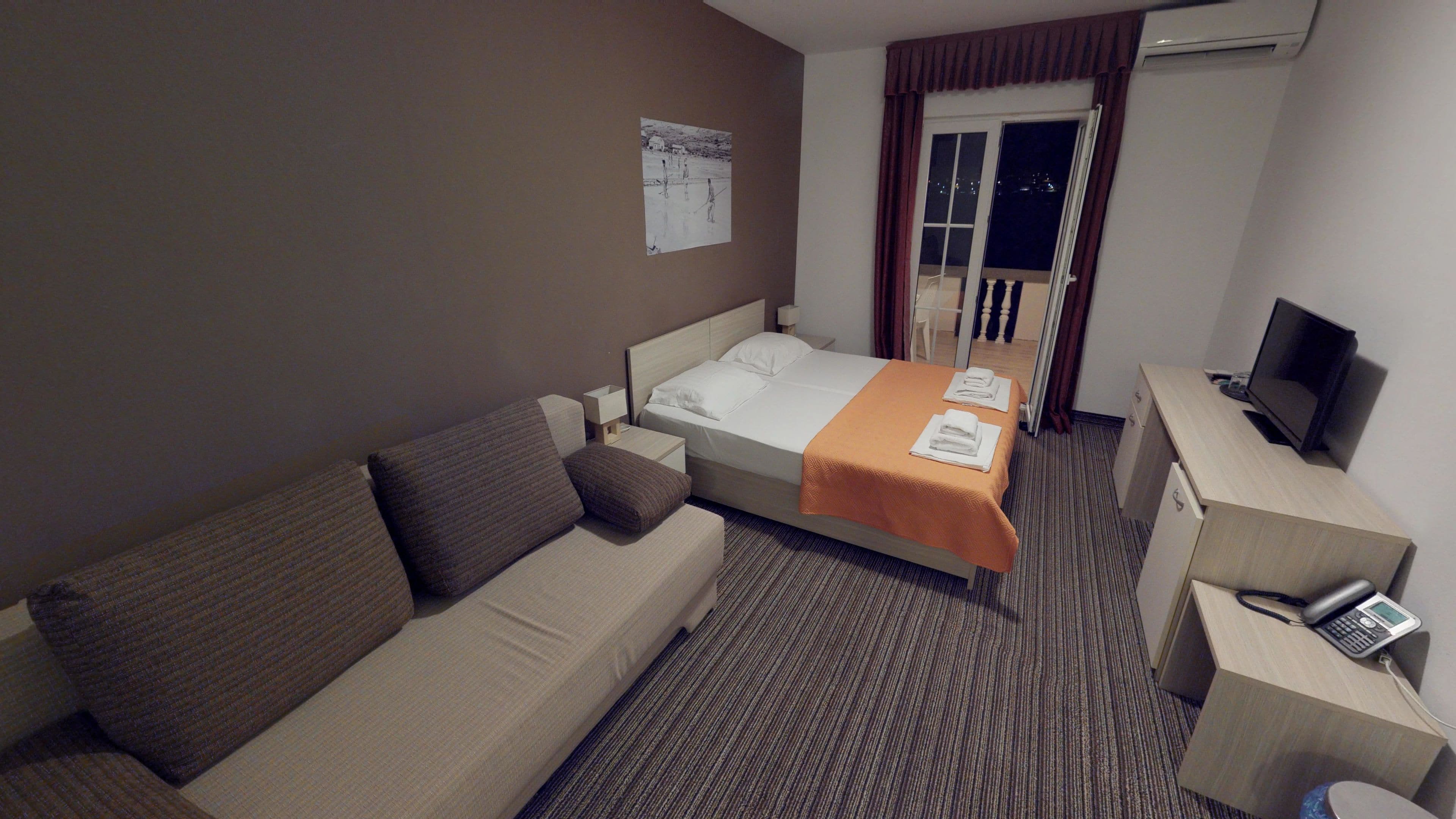 family room, balcony, sea view | minibar, in-room safe, desk, blackout curtains