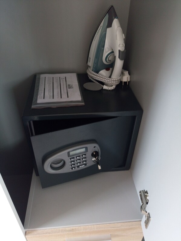 A compact storage unit with a built-in radio and a small drawer.