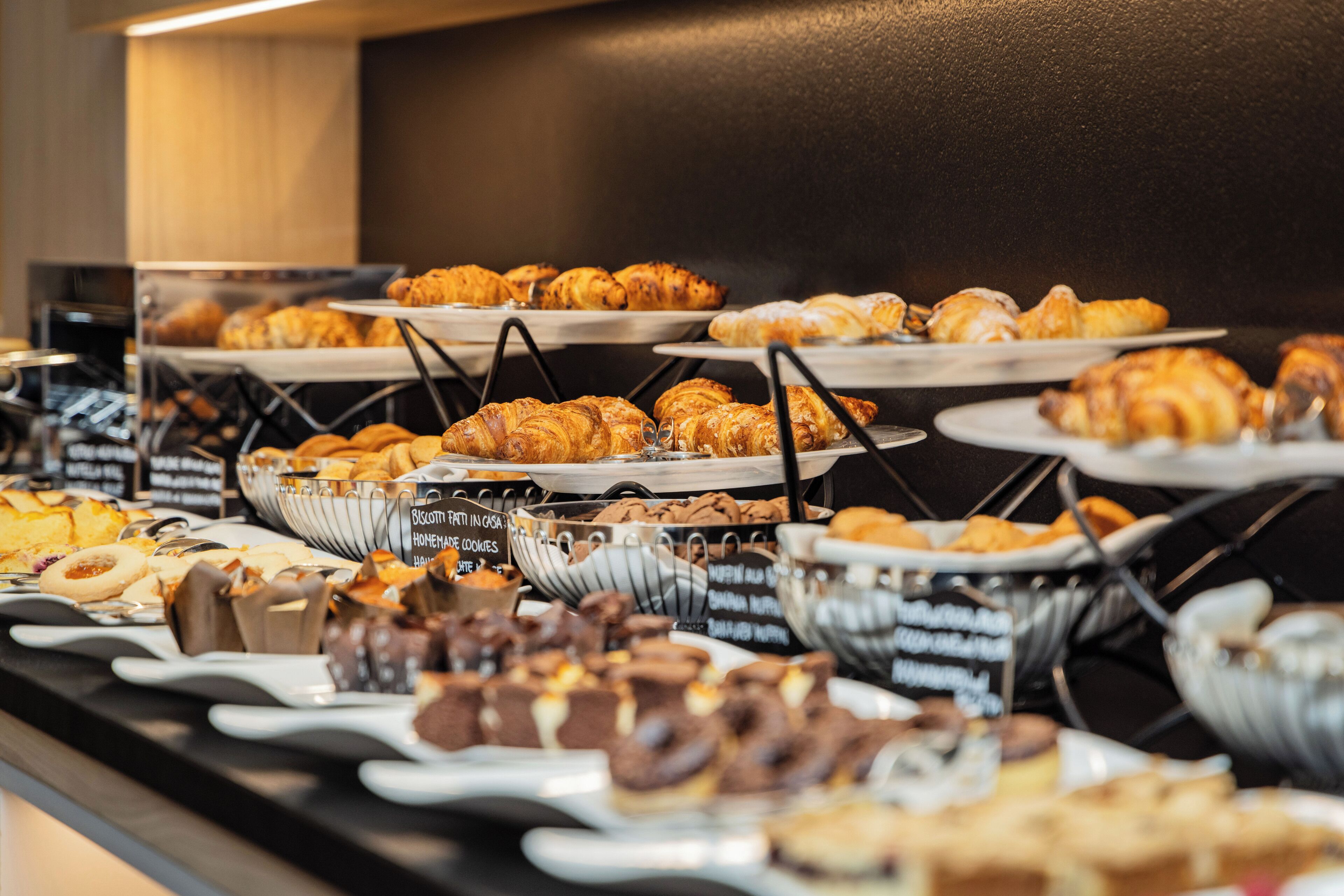 A buffet with various pastries and desserts.
