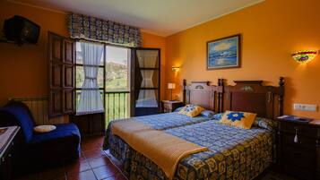 A bedroom with a bed, a chair, a nightstand, a lamp, and a painting on the wall.