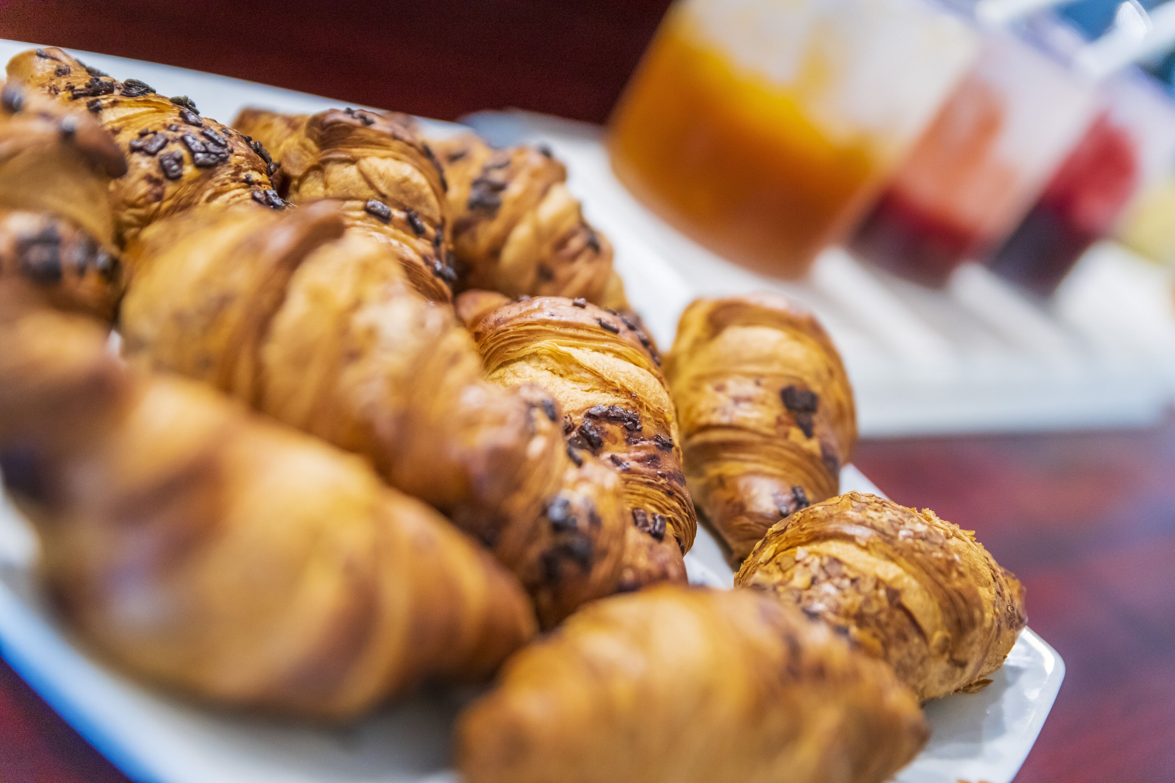 A plate of croissants with chocolate chips.