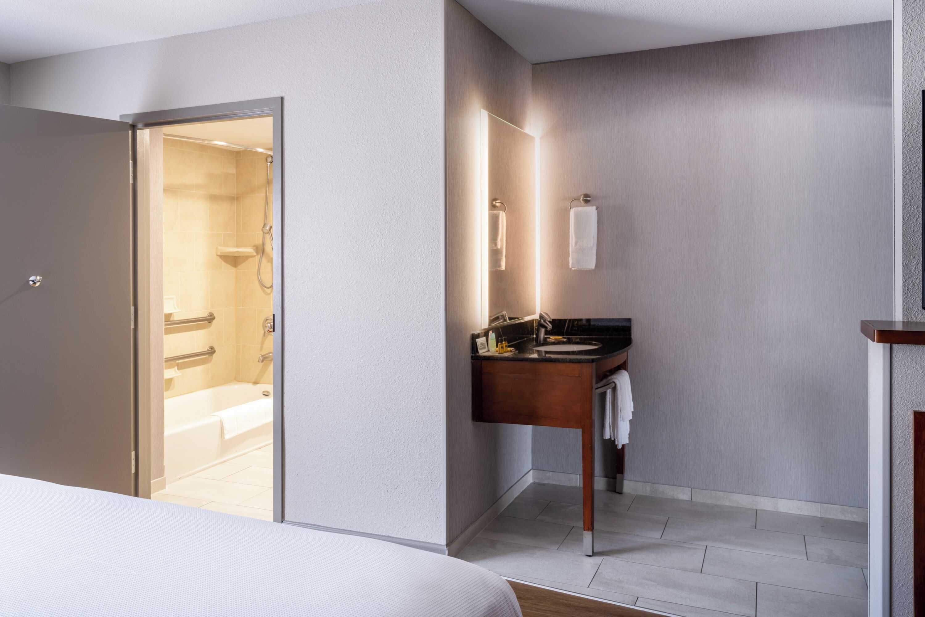 combined shower/bathtub, designer toiletries, hair dryer, towels