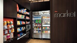 A self-service grocery area with refrigerated sections and shelves stocked with snacks and beverages. - Courtyard by Marriott Tyler (Tyler)