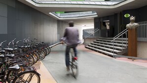A modern building with a bike parking area and a staircase leading to an upper level. - Hotel Gat Point Charlie Berlin (Berlin)