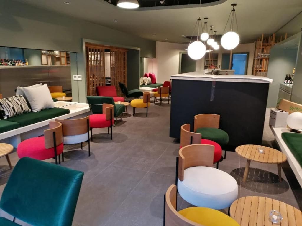 Ein moderner Loungebereich mit Sitzgelegenheiten, einer Bar und einer Theke.