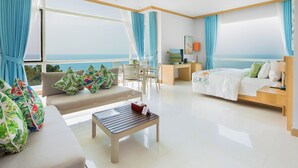 A modern hotel room with a balcony, a sofa, a bed, and a desk. - Independence Hotel by Dara (Sihanoukville)