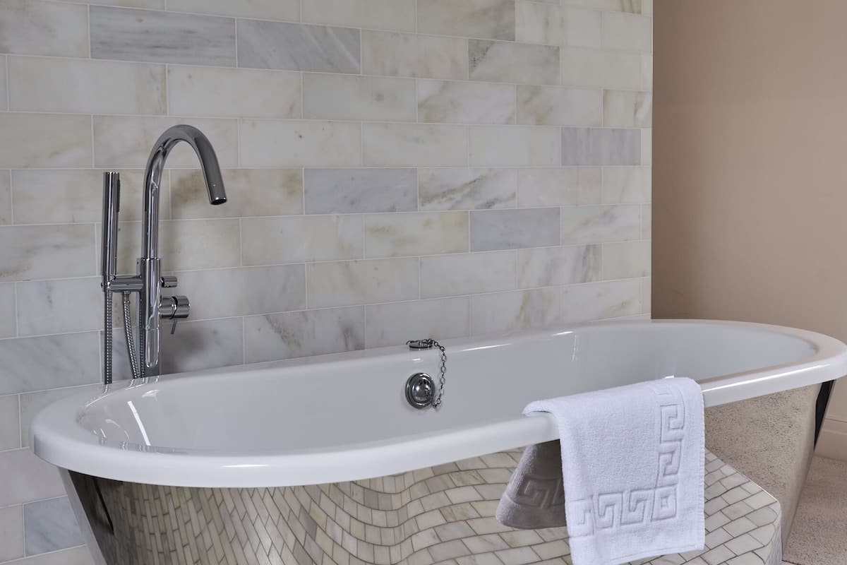 manor suite | bathroom | eco-friendly toiletries, hair dryer, slippers, towels