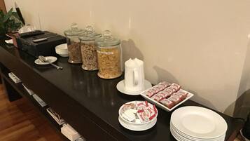 A buffet setup with various food items and utensils.