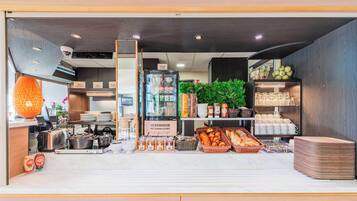 A reception area with a reception desk, a refrigerator, baskets of bread, and a display of eggs.