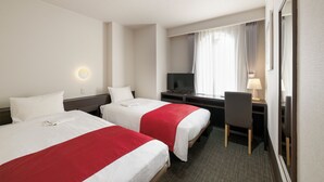 A hotel room with two beds, a desk, a chair, a TV, and a window with curtains. - Hotel Horidome Villa (Tokyo)