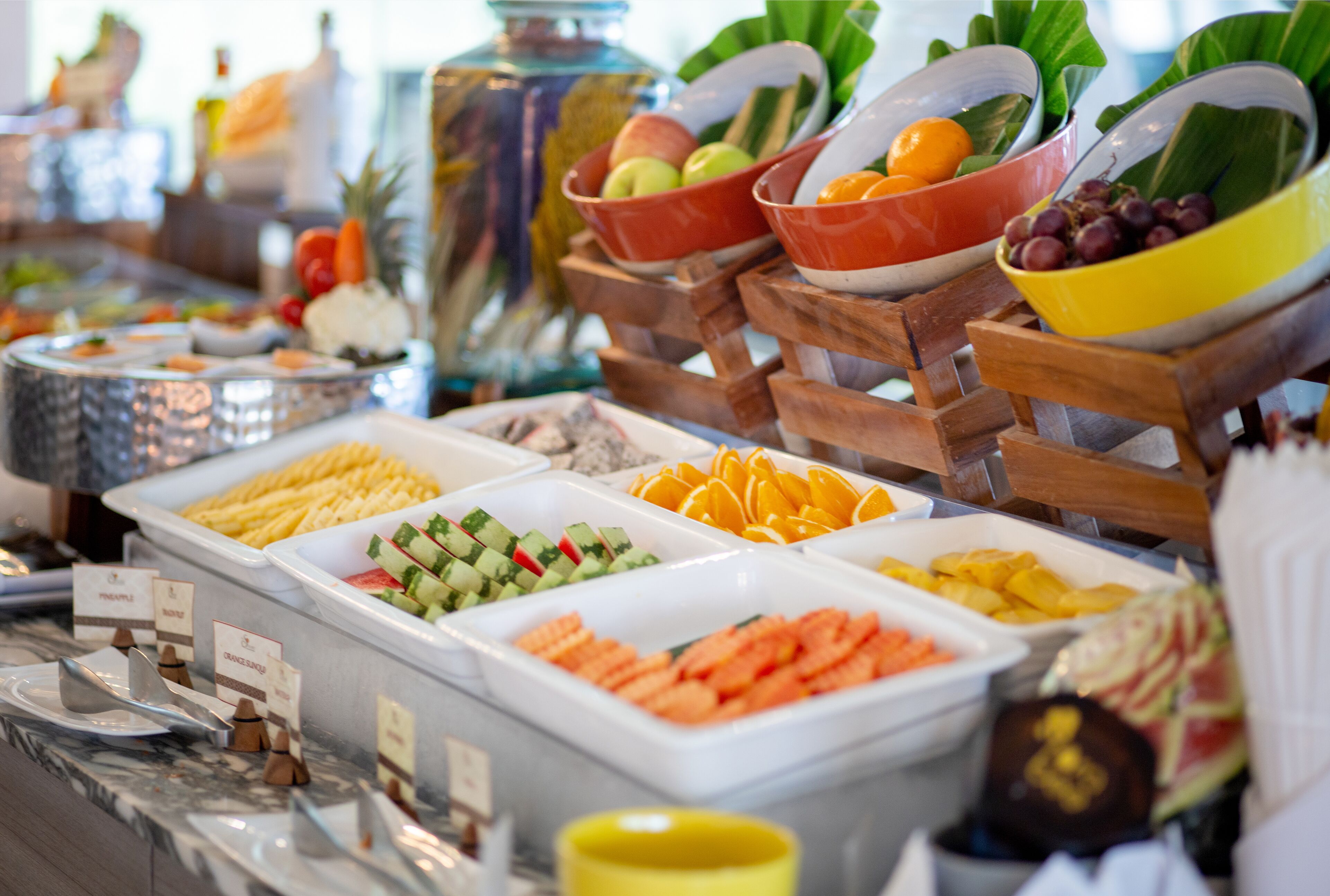 A buffet with various food items and a decorative centerpiece.