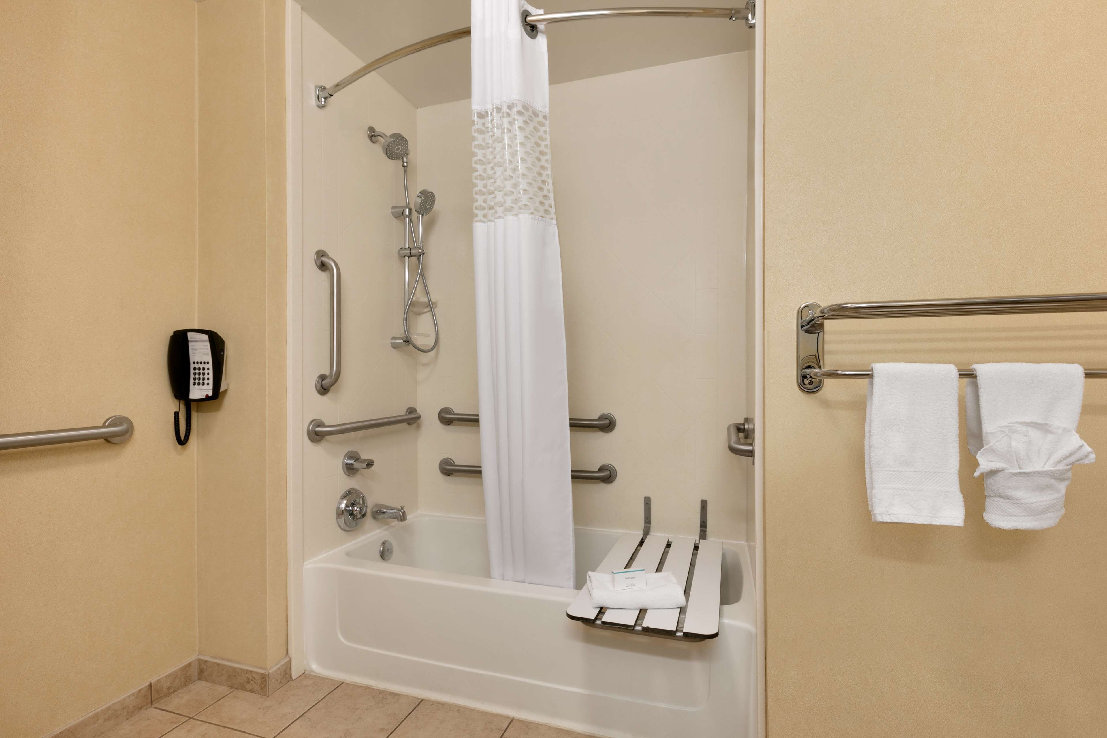 combined shower/bathtub, designer toiletries, hair dryer, towels