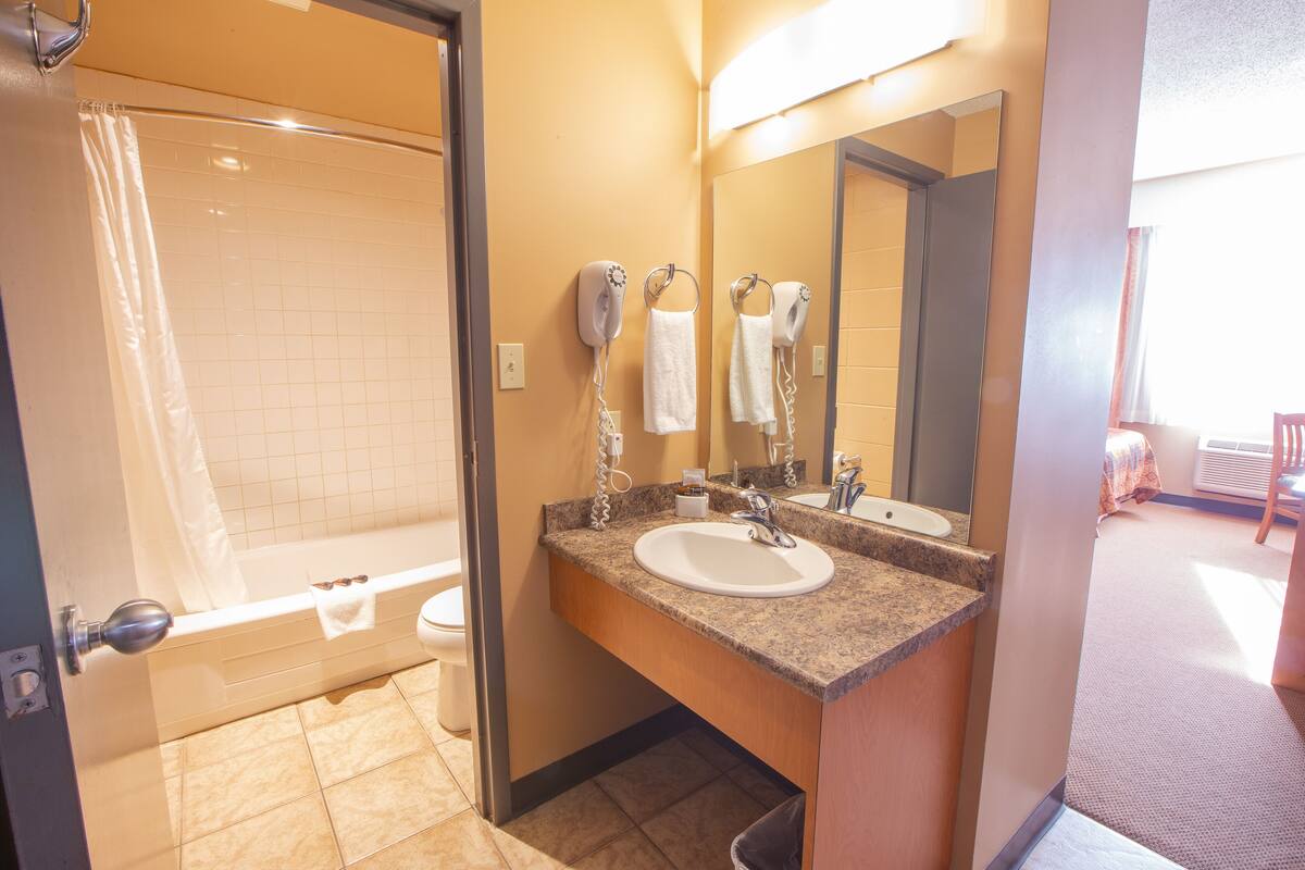 shower, rainfall showerhead, hair dryer, towels