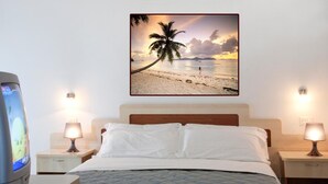 A hotel room with a bed, two bedside tables, a television, and a wall-mounted picture of a beach scene. - Residence Mediterraneo (Rimini)