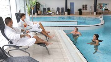 A pool area with lounge chairs and a poolside bar.