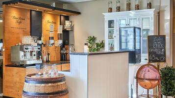 A coffee shop with a wooden counter, coffee machines, and a globe on a stand.