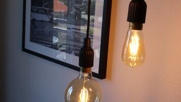 Three hanging light bulbs with visible filament bulbs.