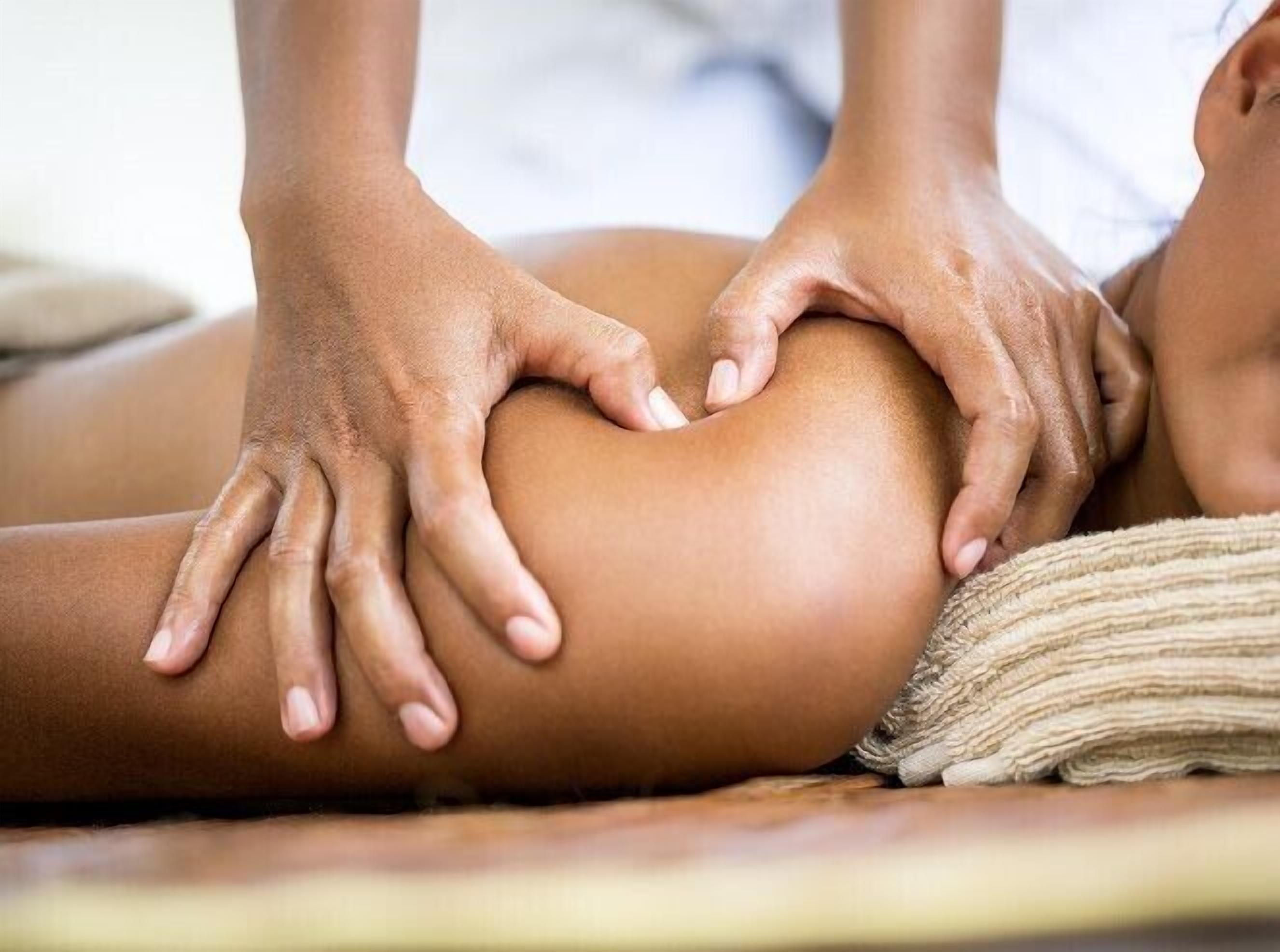 A person receiving a massage on a massage table.