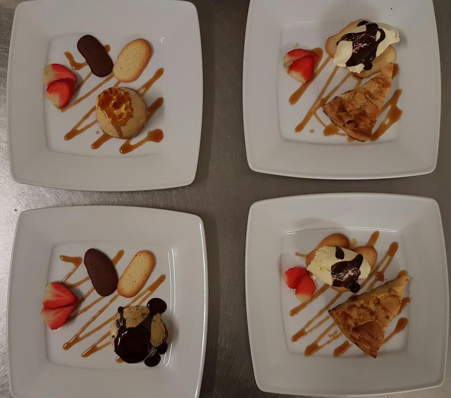 Four square plates with various desserts and fruits.