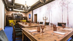 A large conference room with a long wooden table set for a meeting, surrounded by chairs. - Narva Hotell & Spa (Narva)