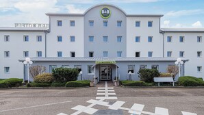 A B&B hotel with a central entrance, multiple windows, and a clear sky. - B&B HOTEL Strasbourg Aéroport (Holtzheim)