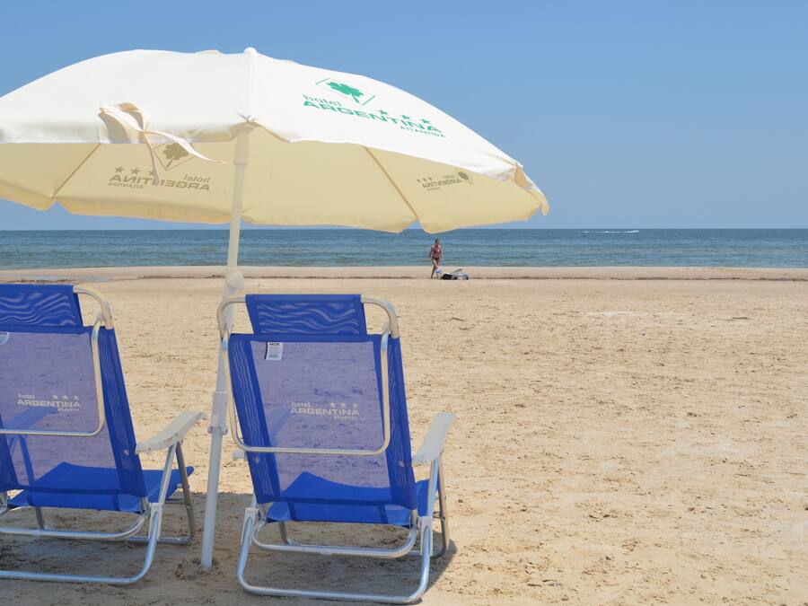 Beach nearby, white sand, beach umbrellas, beach towels