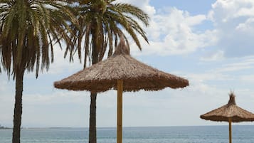 On the beach, sun-loungers, beach umbrellas, beach towels
