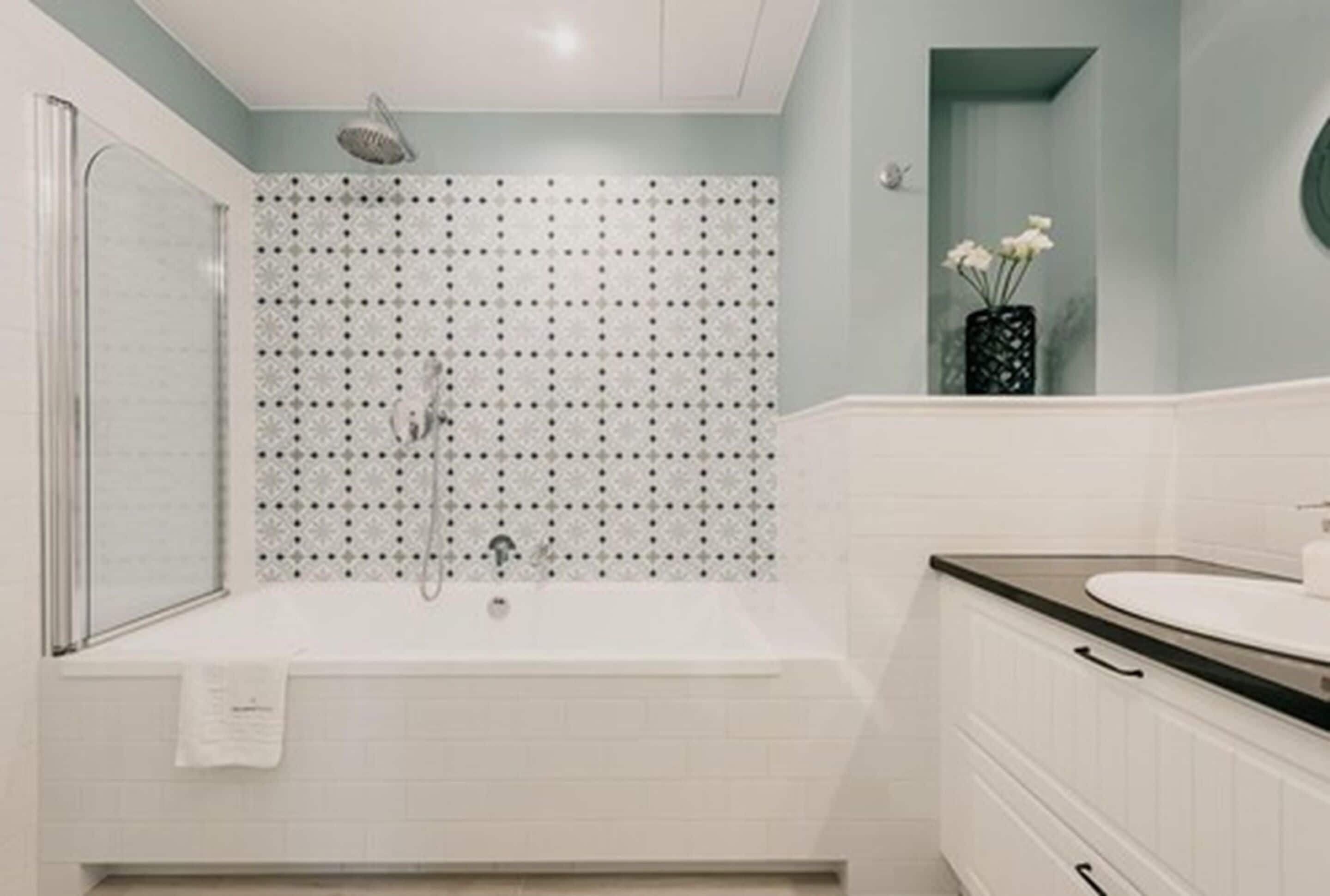 A modern bathroom with a freestanding bathtub, a shower, and a vanity with a sink.