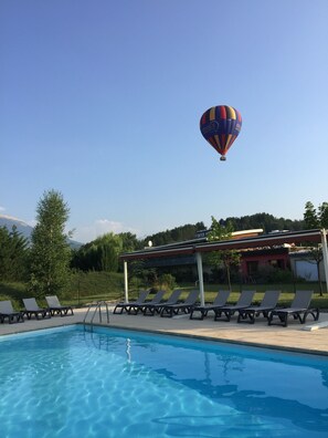 Seasonal outdoor pool, open 9:30 AM to 8:00 PM, pool umbrellas