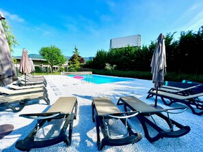 Seasonal outdoor pool, open 9:30 AM to 8:00 PM, pool umbrellas