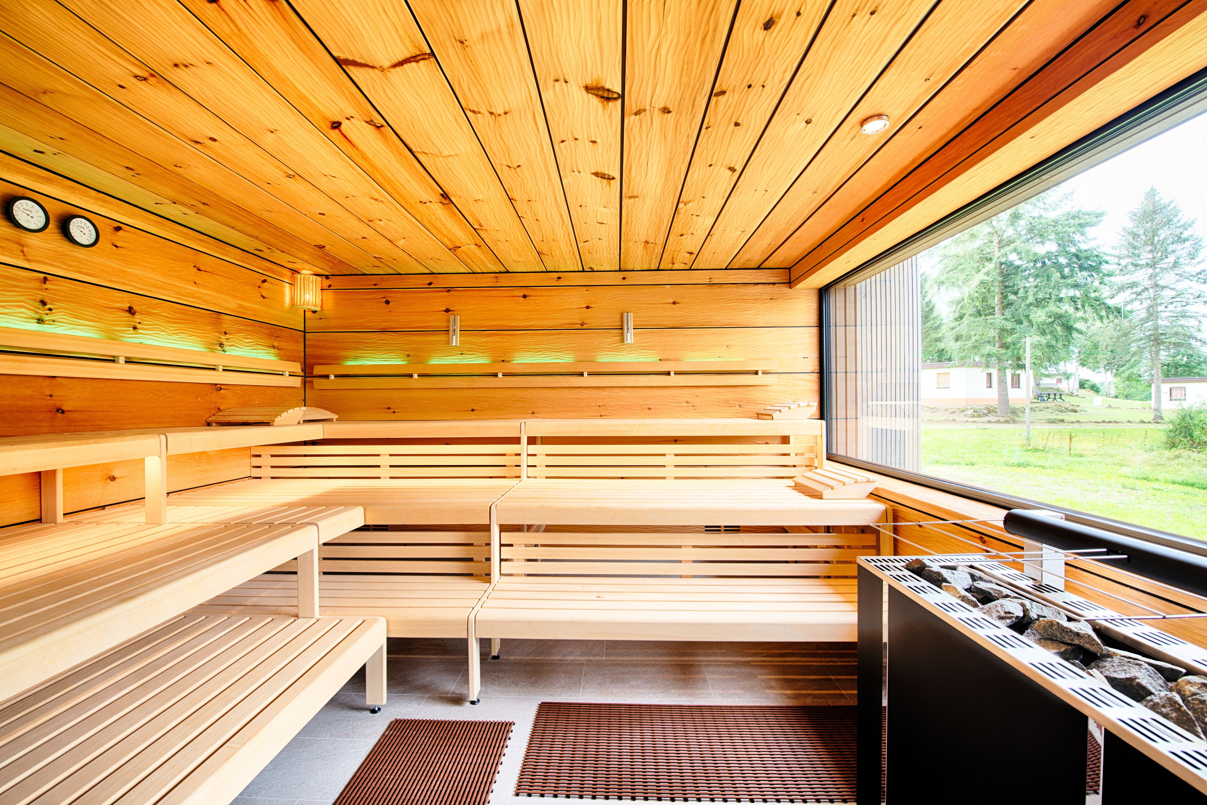 A sauna with wooden benches and a window.