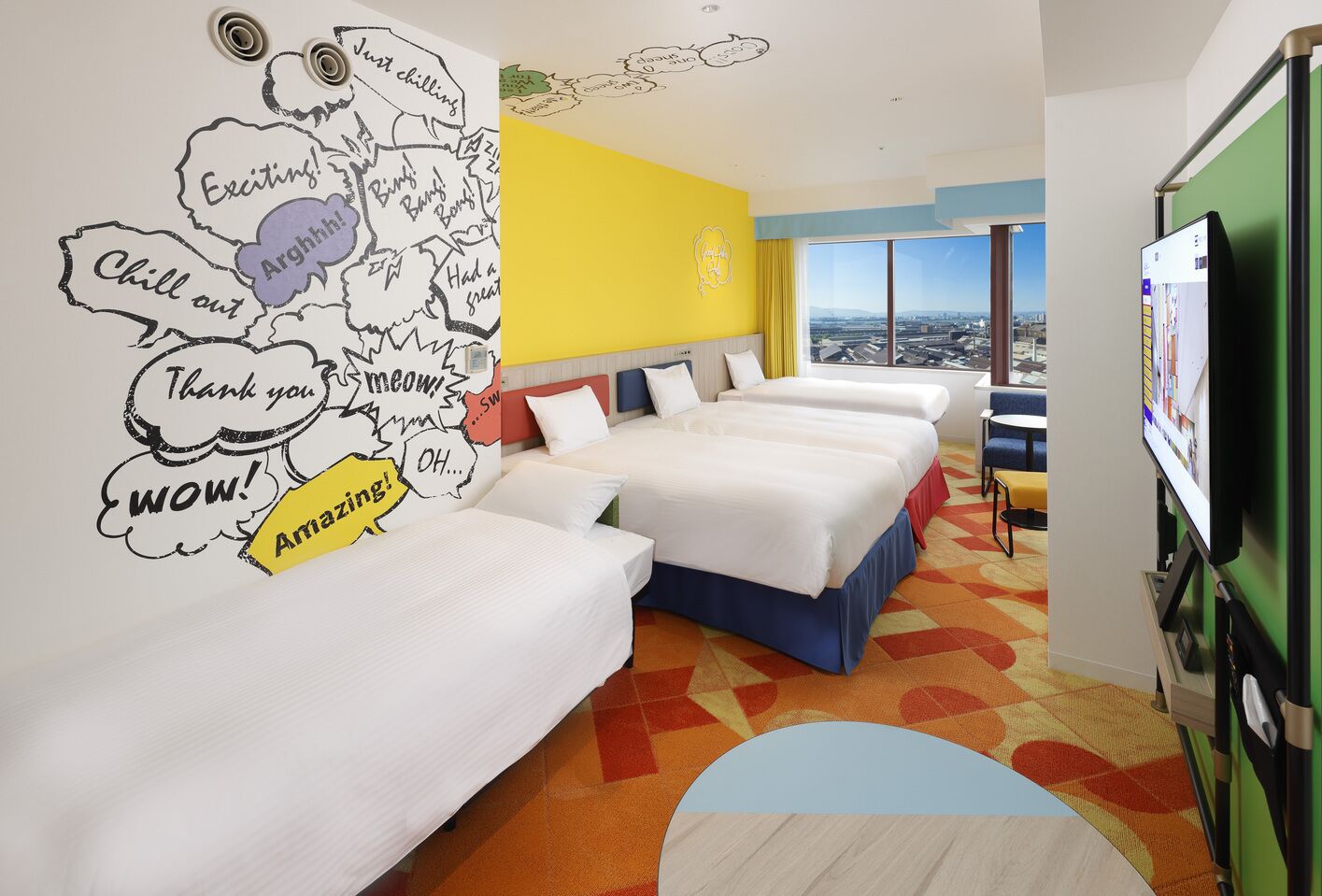 A hotel room with three beds, a city view, a large window, and a wall with speech bubbles.