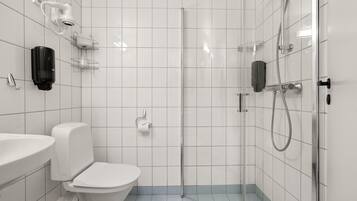 A modern bathroom with a toilet, sink, and shower.