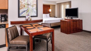 A hotel room with a bed, a TV, a desk with a chair, a coffee maker, and a map on the wall. - Residence Inn Florence Marriott (Florence)