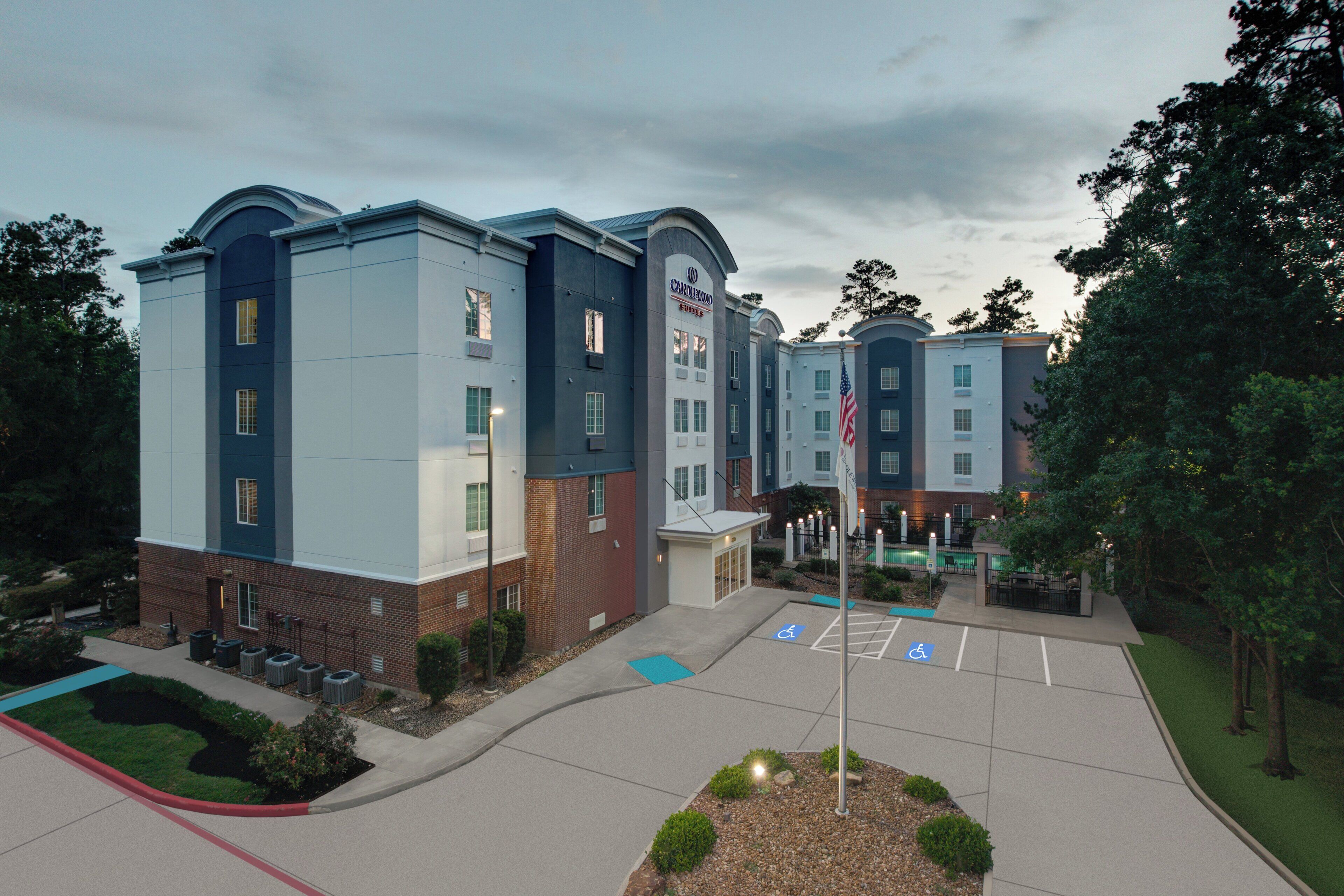 A multi-story hotel with a modern design, featuring a brick facade and a blue and white color scheme.
