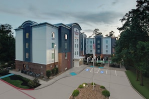 A multi-story hotel with a modern design, featuring a brick facade and a blue and white color scheme.