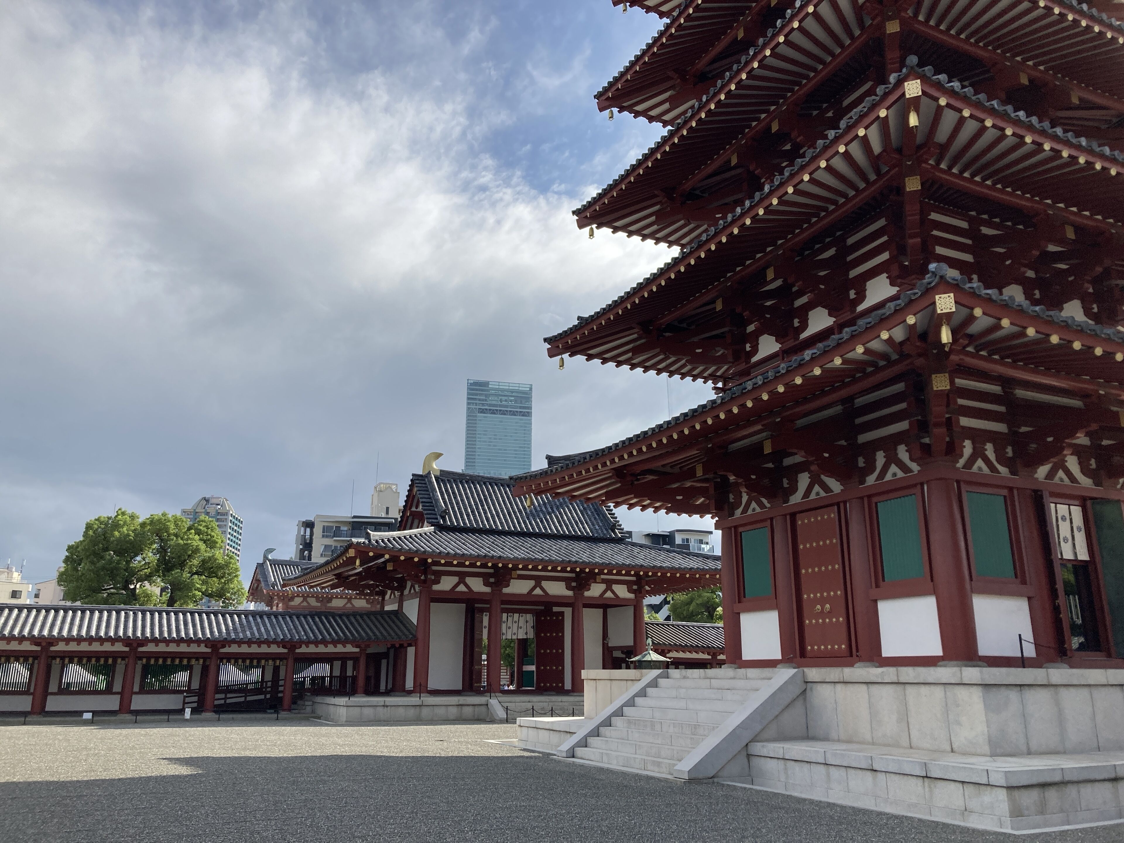A traditional Japanese building with multiple tiers and a stone staircase leading up to the entrance.