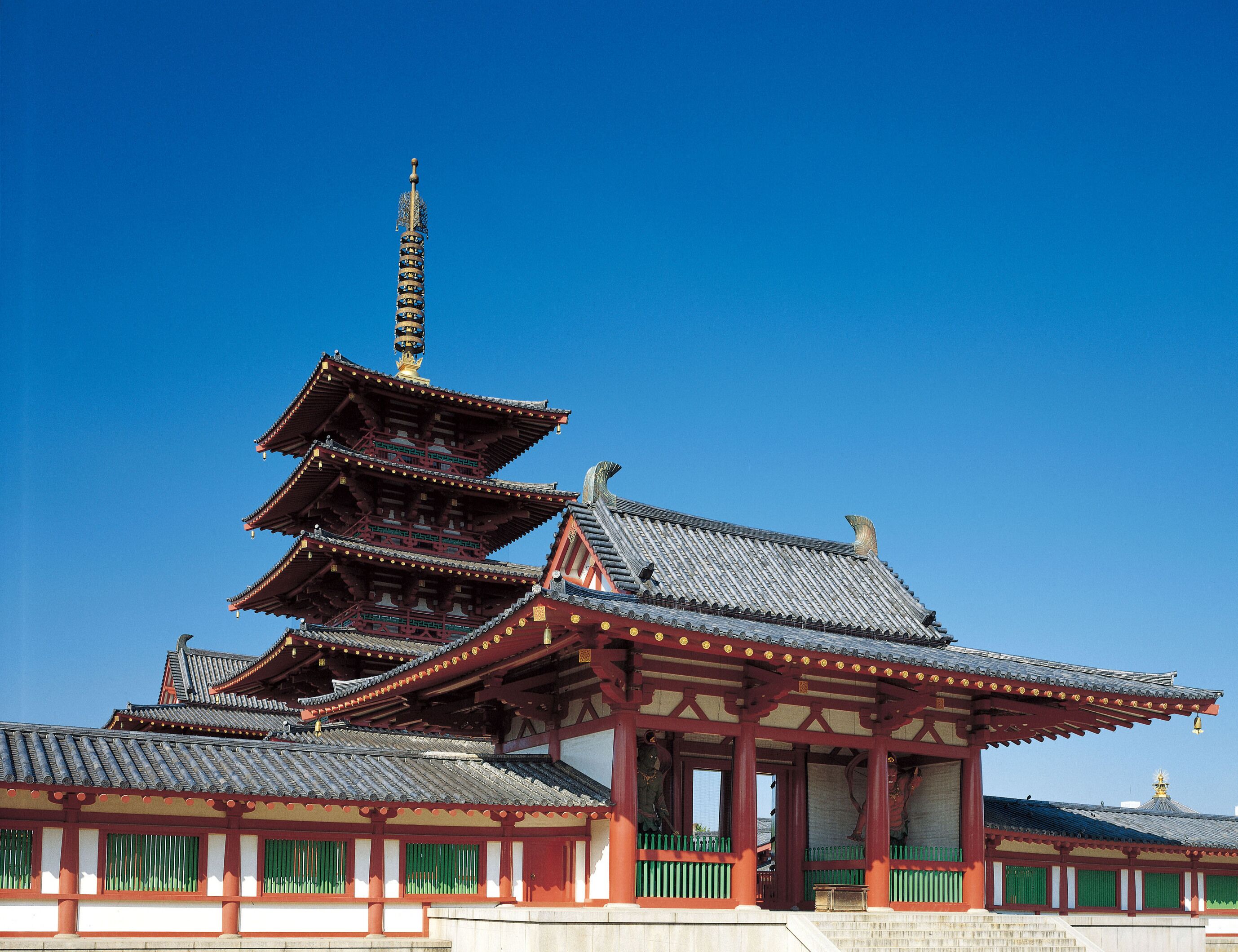 A traditional multi-tiered pagoda with a clear blue sky in the background.