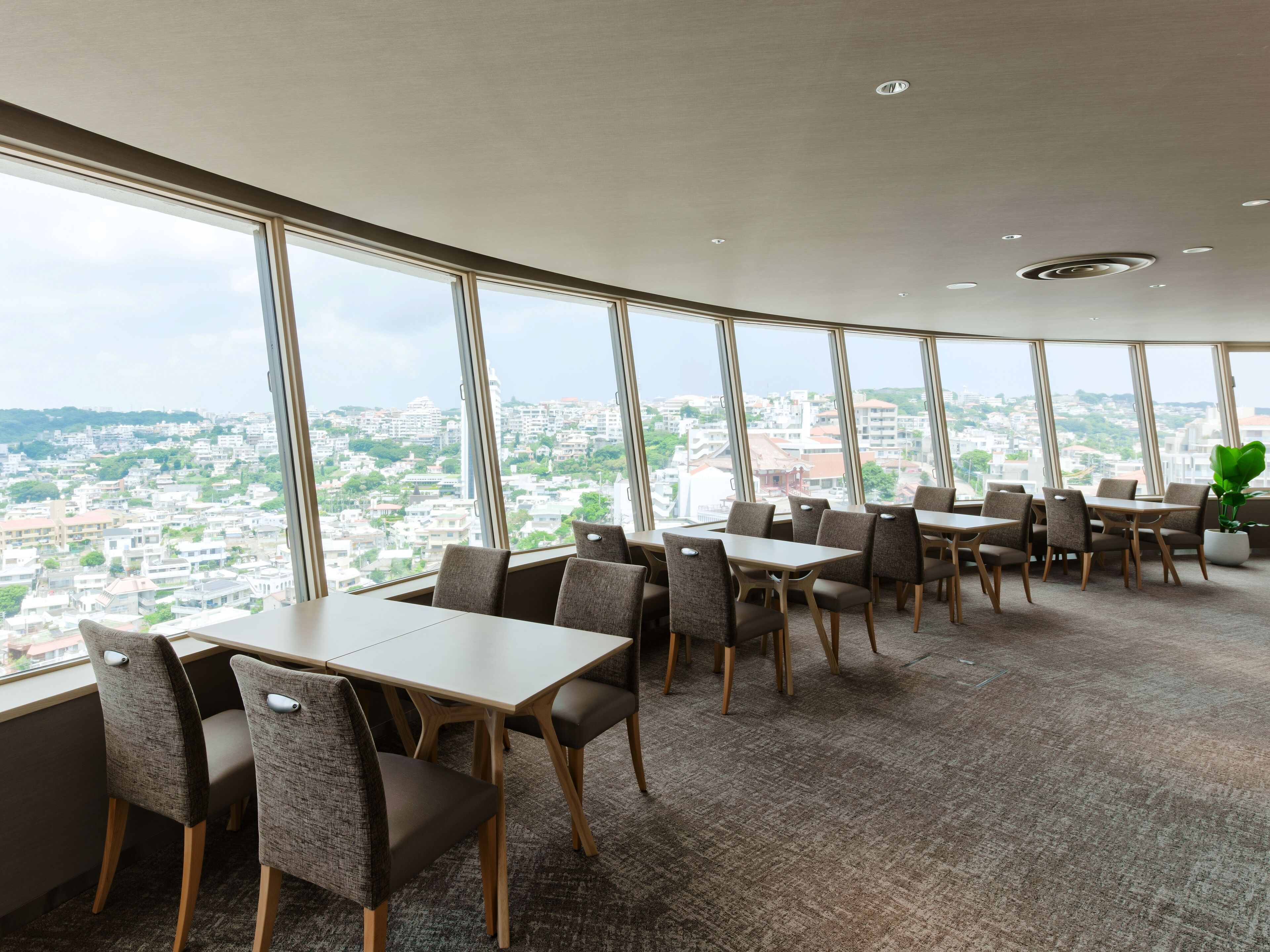 A modern dining area with large windows offering a city view.