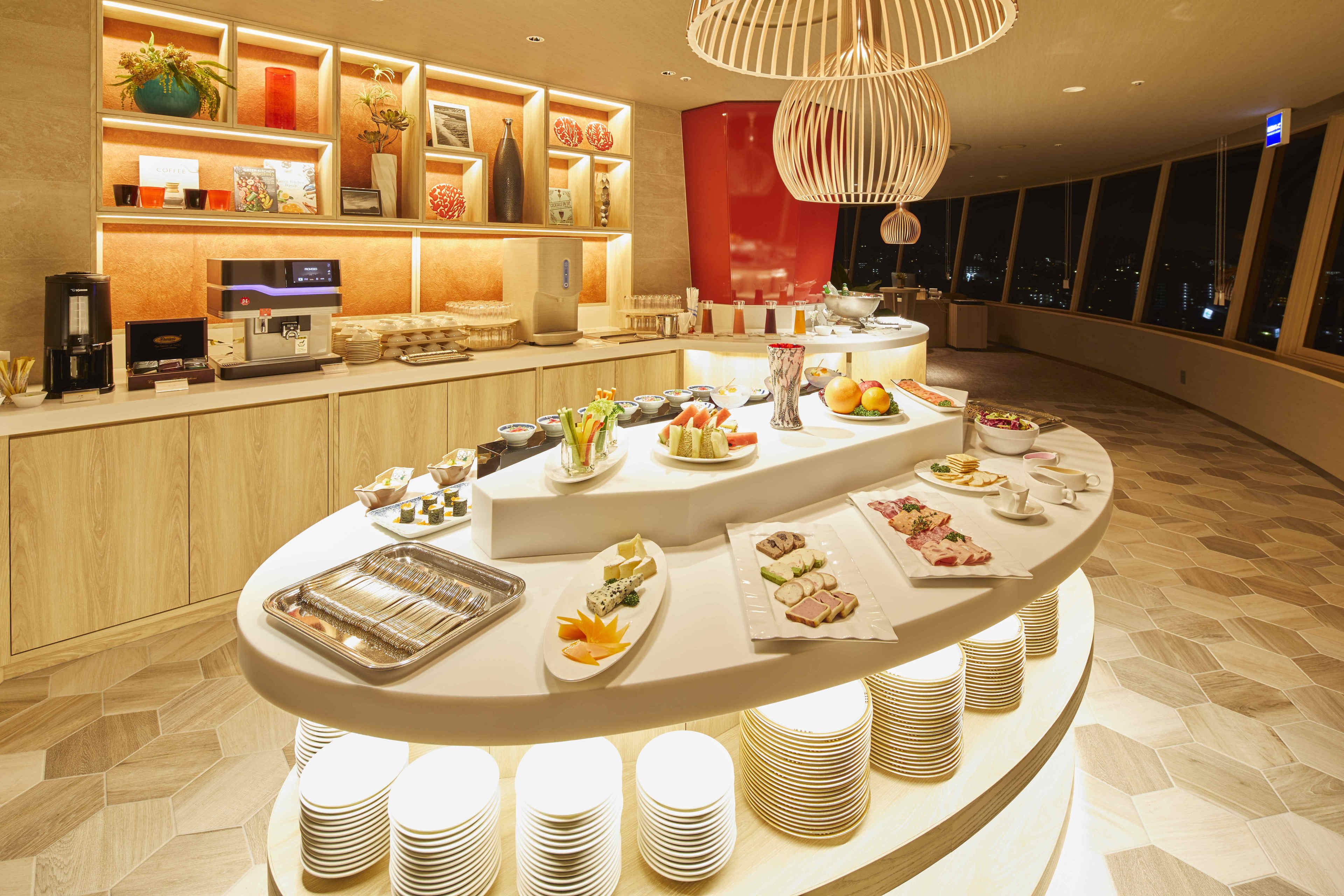A buffet setup with various food items and a coffee station.