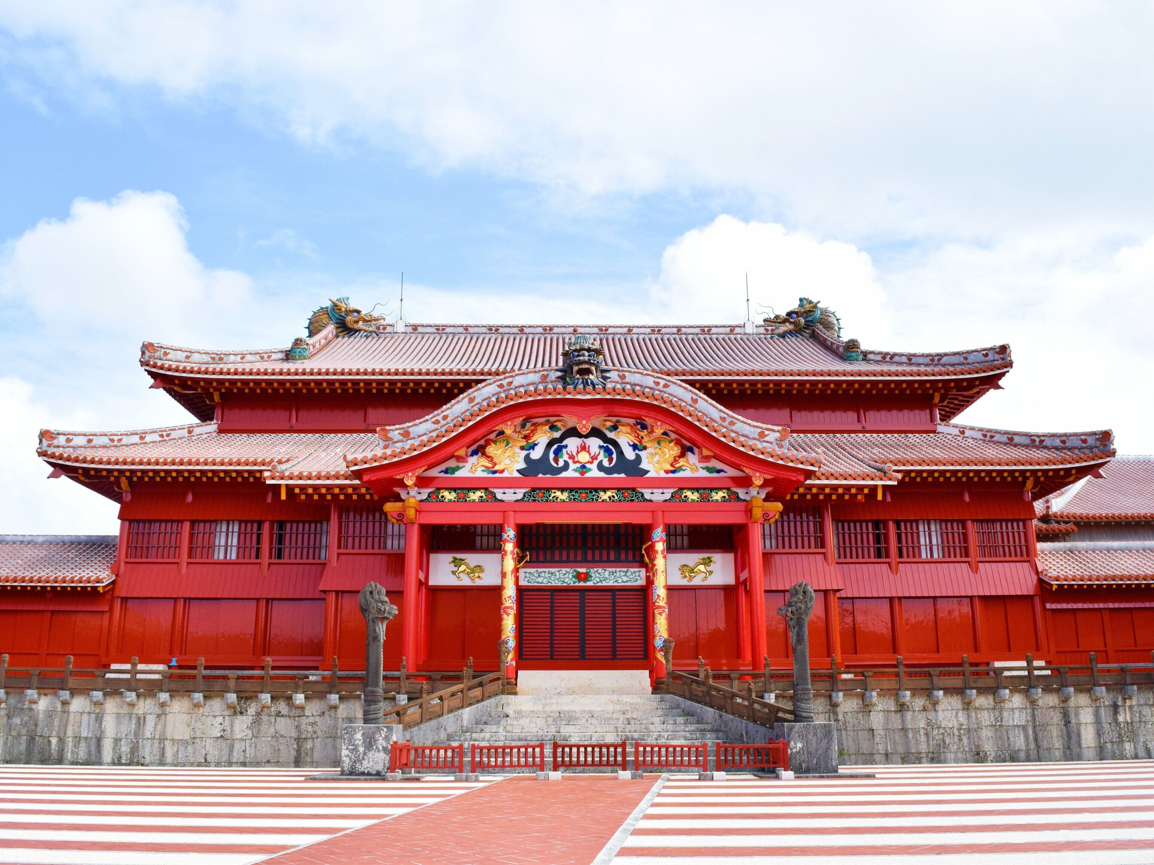 A traditional red building with a multi-tiered roof and ornate decorations.