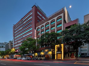 A multi-story hotel with a prominent entrance, large windows, and a visible sign indicating it is a hotel. - Guide Hotel Taipei Fuxing N (Taipei)