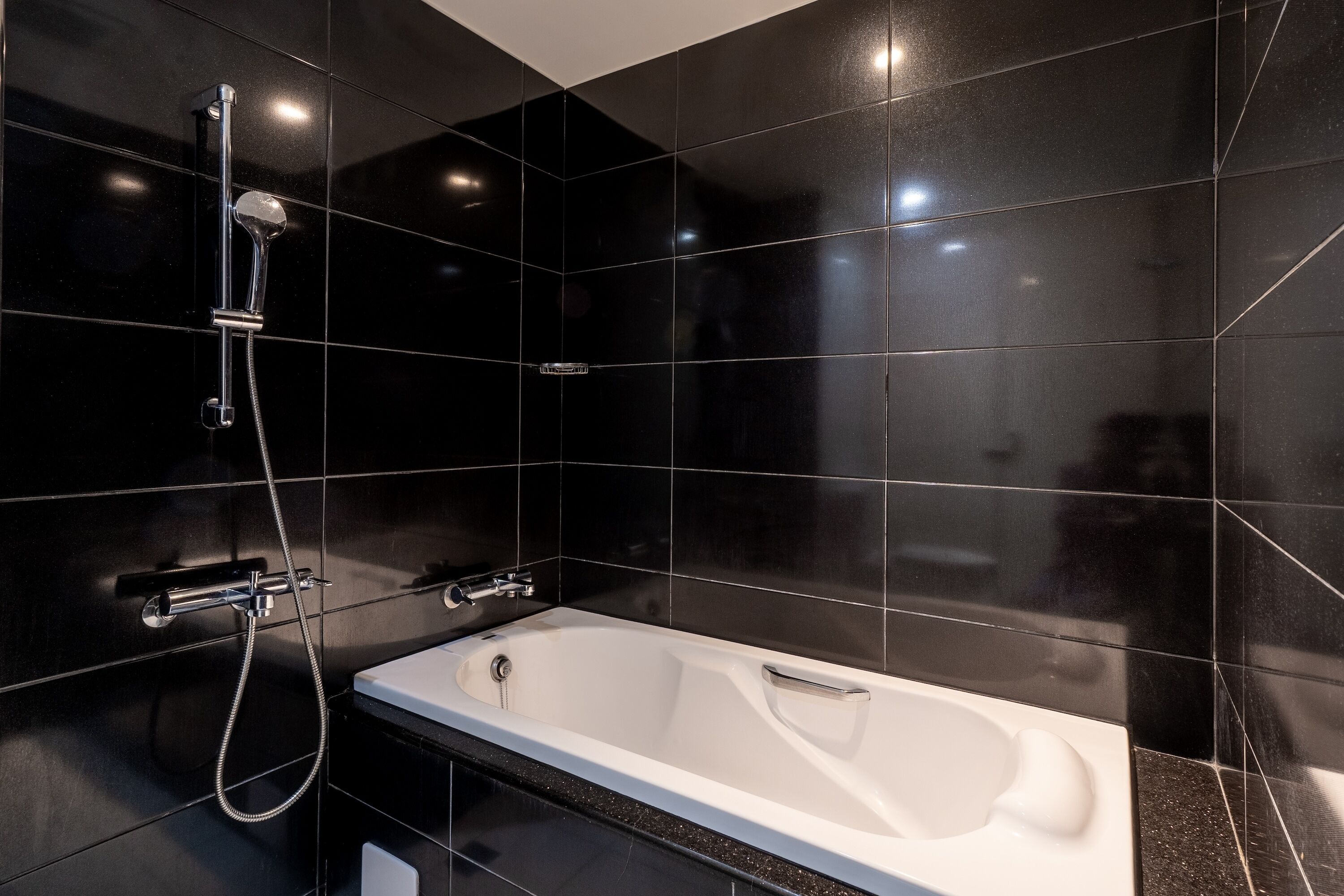 deluxe suite | bathroom | shower, rainfall showerhead, hair dryer, towels