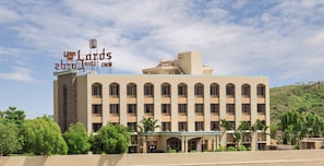 A hotel with a prominent sign, multiple floors, and a flat roof.