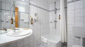 A modern bathroom with a large sink, mirror, shower, and toilet. - Egreta (Tulcea)