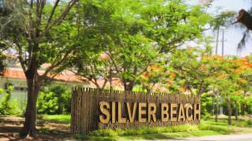 Un letrero de madera con el texto 'SILVER BEACH' en letras mayúsculas.